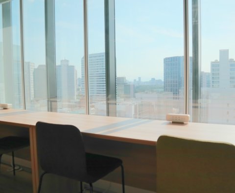大きな窓に面して長いカウンターテーブルと椅子が並べられている。利用者は景色を眺めながら作業や休憩ができる。